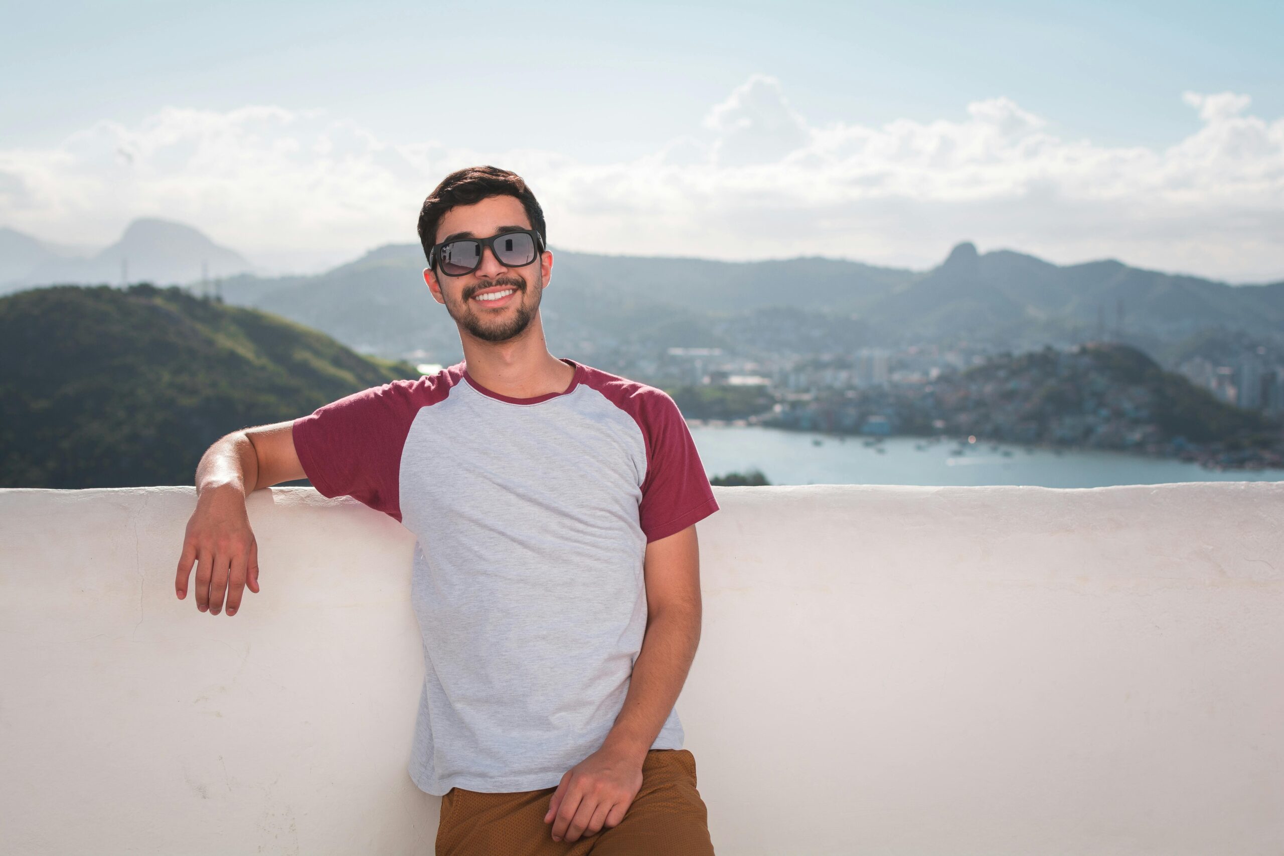 Man Wearing Gray and Red Crew-neck Shirt Smiling