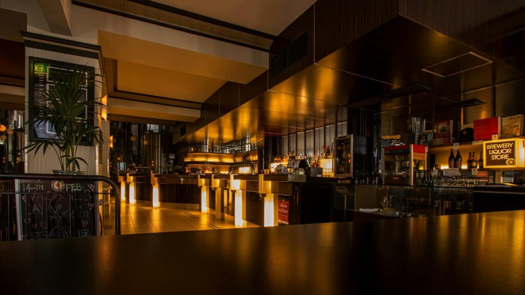 Stylish modern restaurant interior with warm lighting, elegant design, and luxurious ambiance at night.